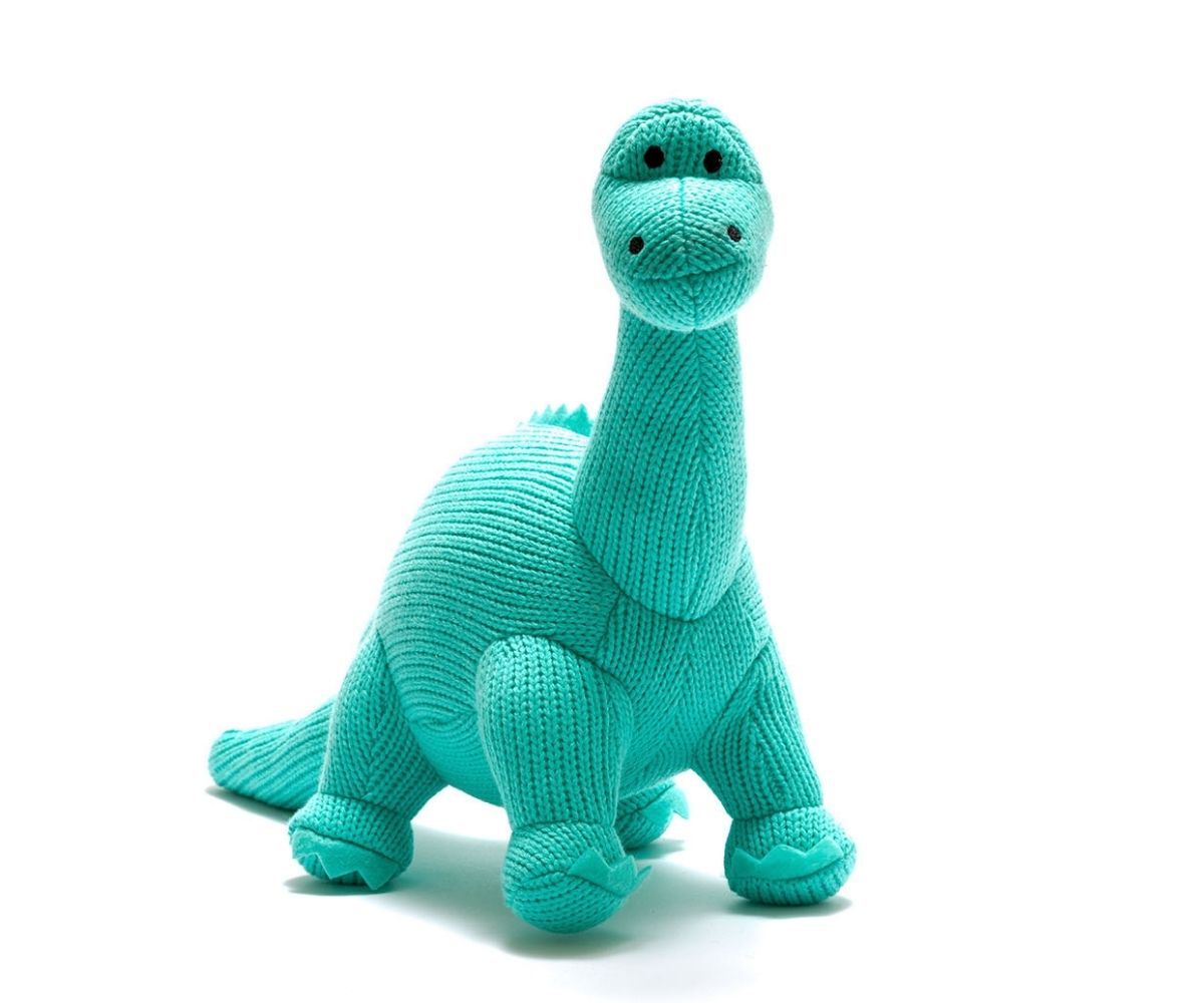 Knitted diplodocus dinosaur soft toy in ice blue colour with long neck and tail and smiley face